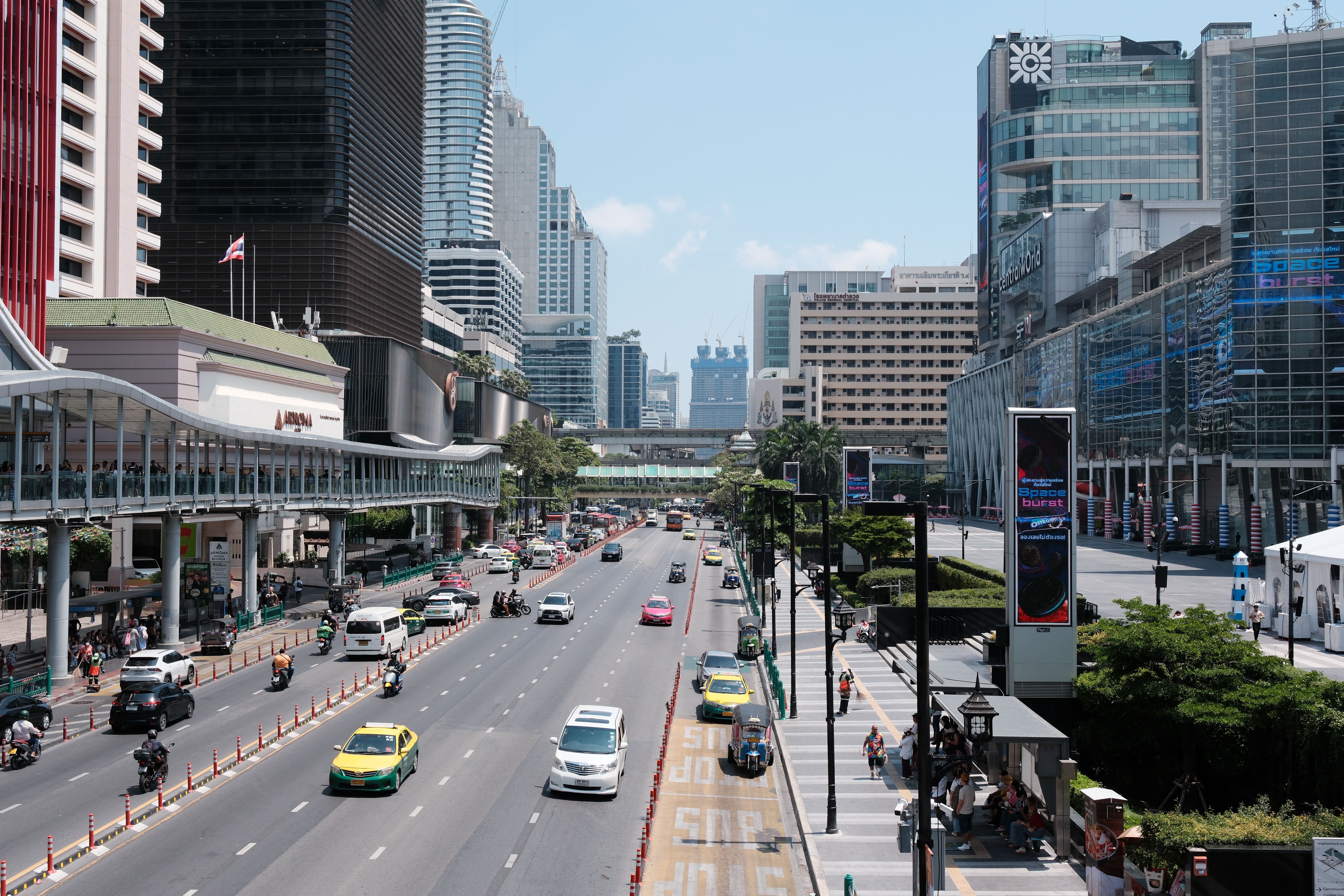A high-angle view of a busy Bangkok street with modern buildings and traffic