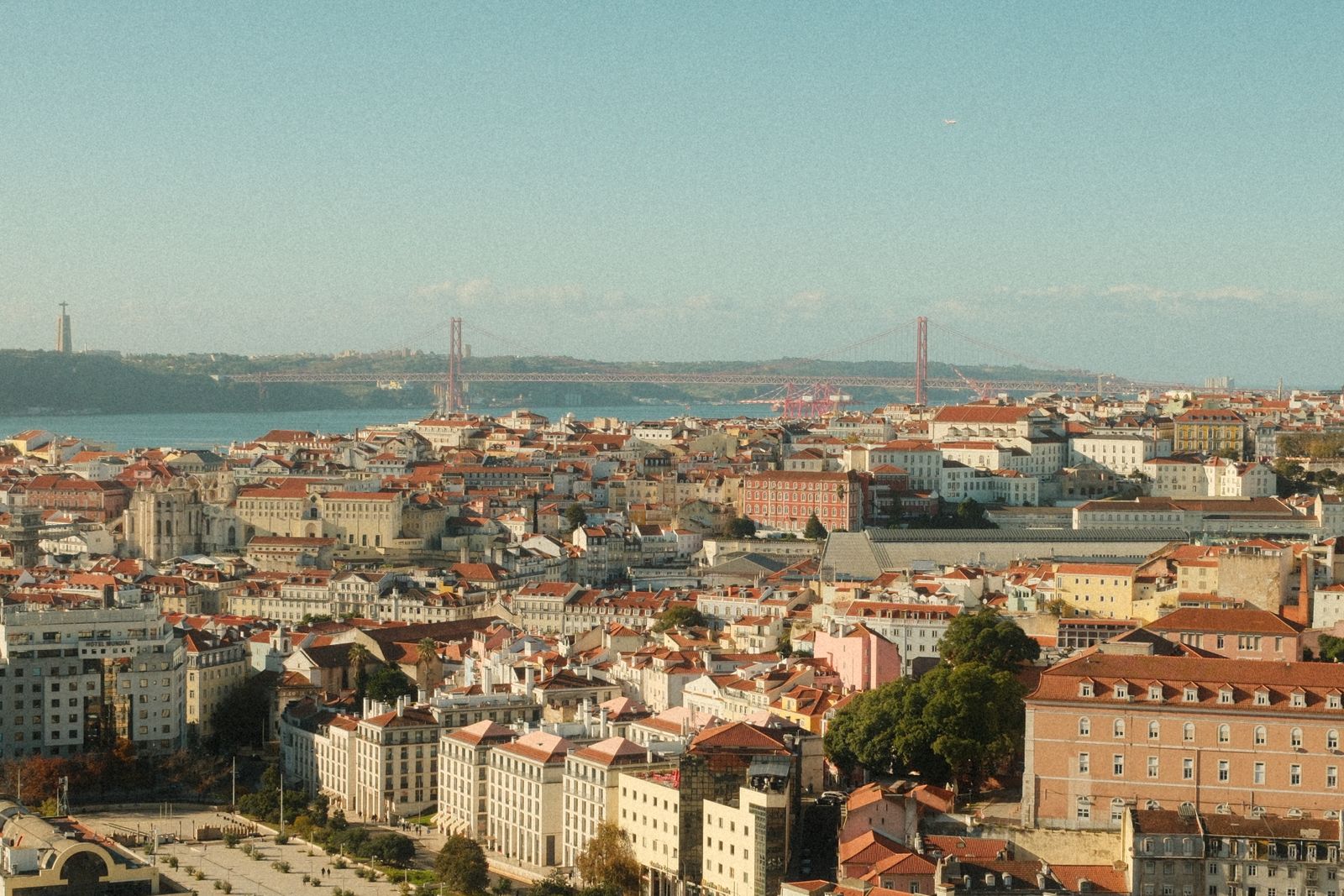 A panoramic view of Lisbon's rooftops, the Tagus and the 25 de Abril Bridge